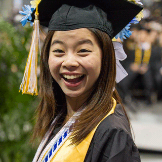 A happy, smiling female Georgia Tech graduate.