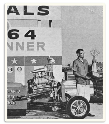 Julius Hughes Jr. holding his 1964 NHRA trophy