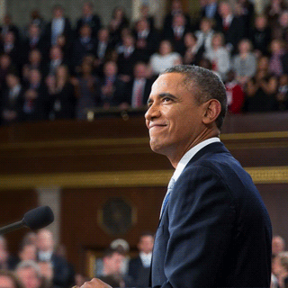 President Obama smiling at a podium.