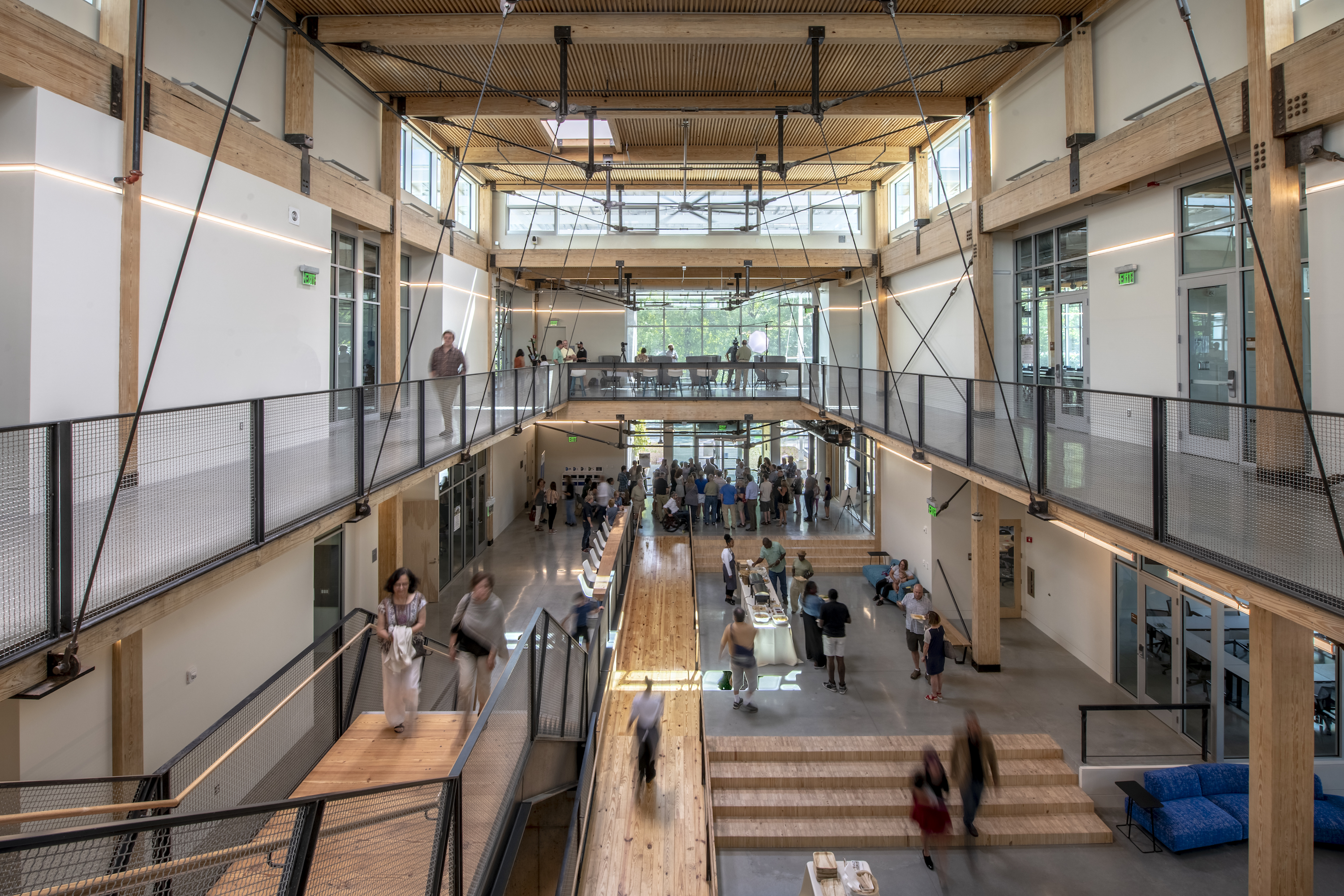 Guests attend the Friends and Family Day in September. The project incorporates reclaimed, recycled, and salvaged wood throughout the building.

Image courtesy of Justin Chan Photography.