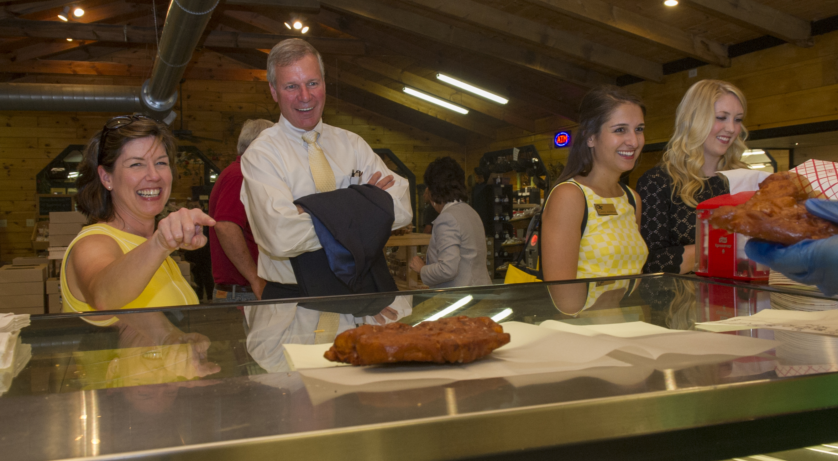 Chief of Staff Lynn Durham orders at Mercier Orchards in Blue Ridge, Georgia as President G.P. "Bud" Peterson watches following a tour of the facility on Thursday, June 18, 2015.