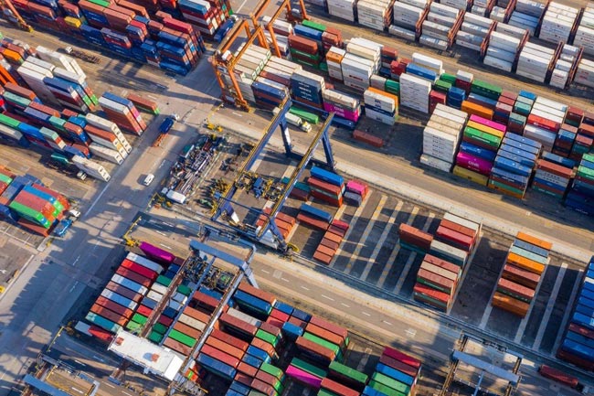 a shipping yard full of shipping containers seen from above