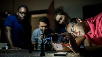 Aaron Metyko, right, demonstrates the use of a portable, modular medical imaging device as Boluwaji Omodele, Farouk Marhaba, and Chloe Collins watch. They created the 3D-printed device to be easily created and used in remote places as part of their internship at the Georgia Tech Research Institute. (Photo: Branden Camp)