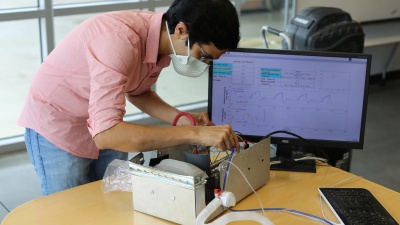 Georgia Tech Researcher Gokul Pathikonda works on the Open-AirVentGT, a low-cost, portable emergency ventilator that uses electronic sensors and computer control to manage key clinical parameters. (Credit: Ben Wright, Georgia Tech)
