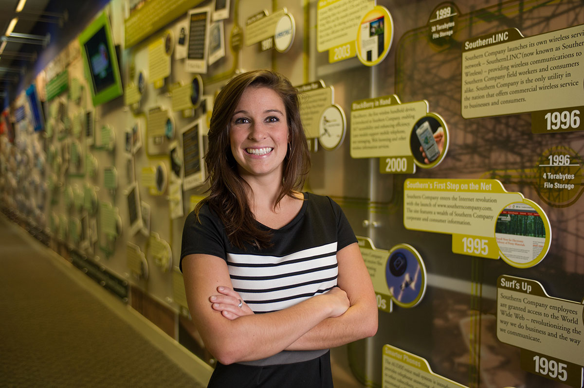 Shannon Mehl poses in front of the historic timeline at Georgia Power.