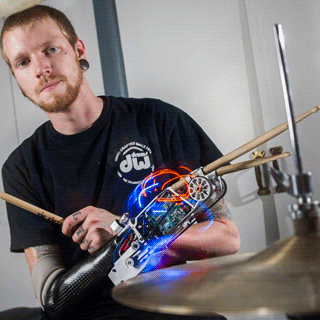 A drummer with a robotic arm that was developed for him by the Georgia Tech School of Music.