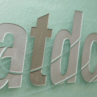 ATDC logo on a frosted glass window.