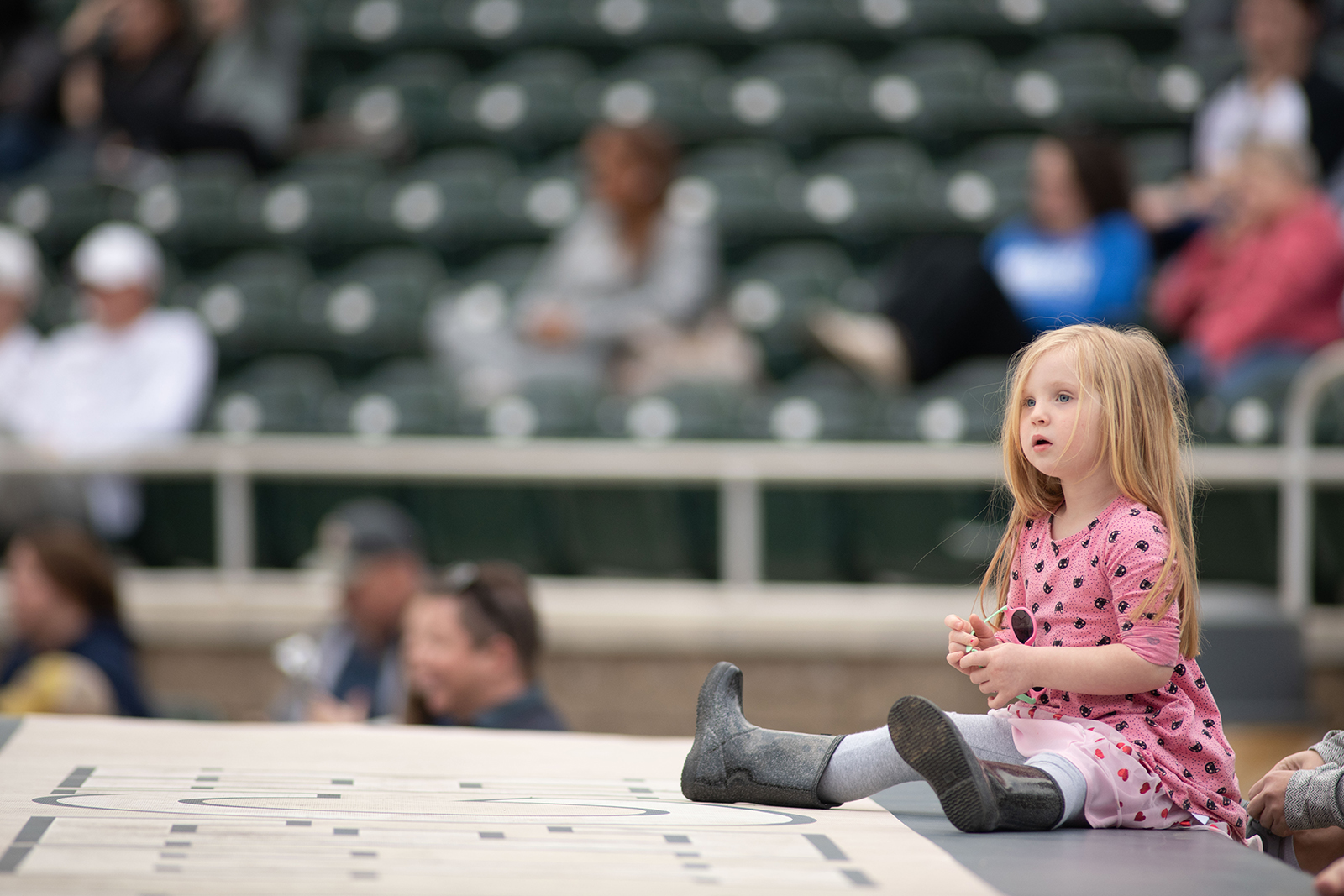 a young girl watches a georgia tech softball game