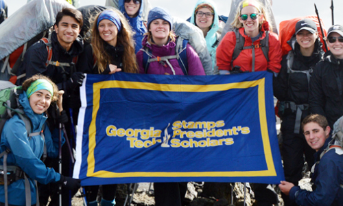 Georgia Tech students display a Stamps Scholars flag