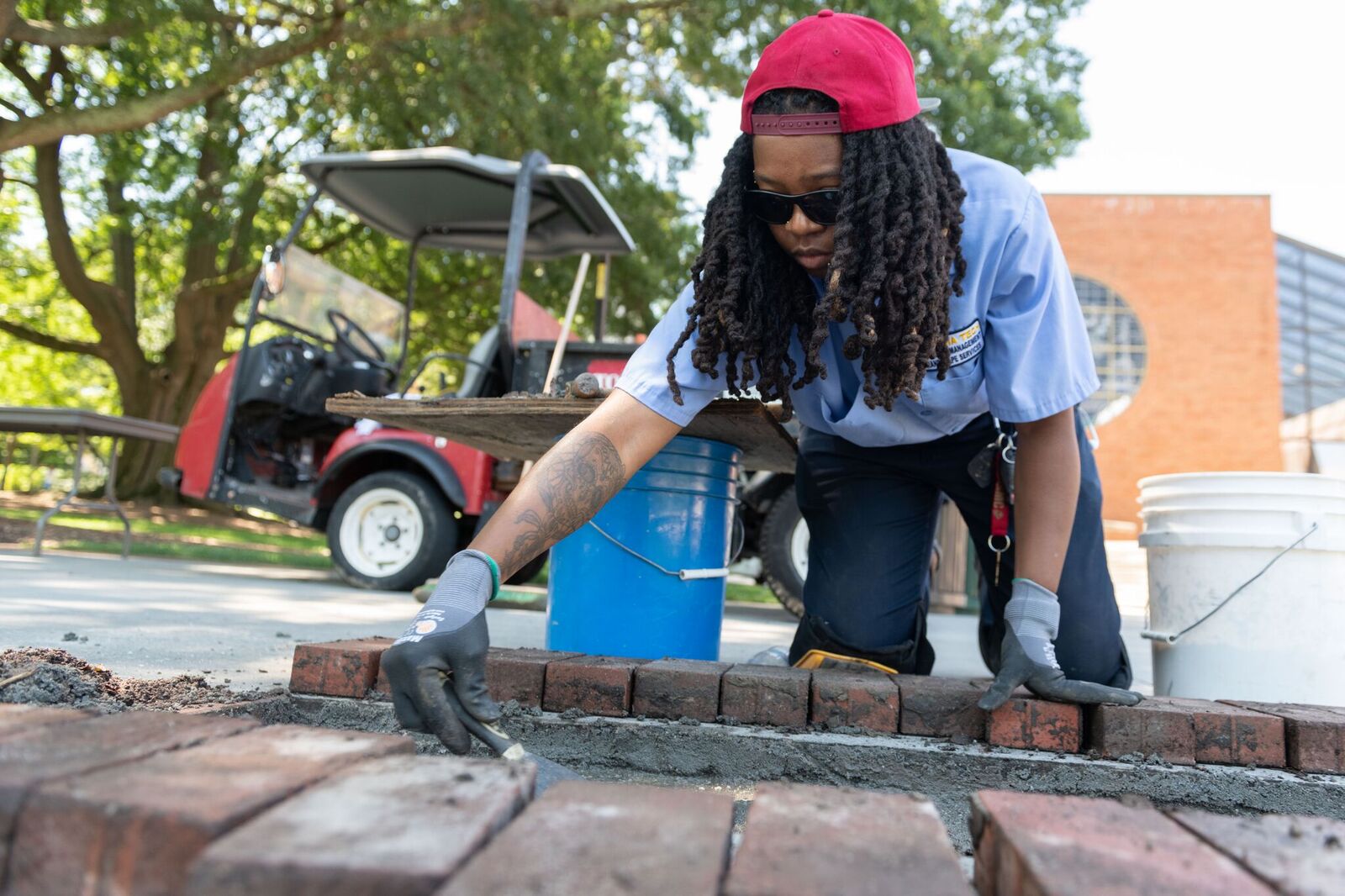 Jasmine Walton, Facilities, repairs brick walkway in front of Student Center