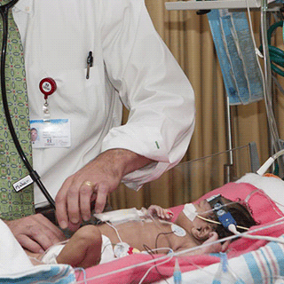 A doctor checks on a young patient.