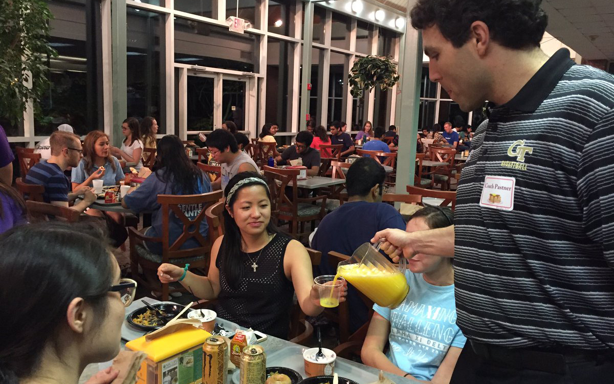 coach pastner pours orange juice