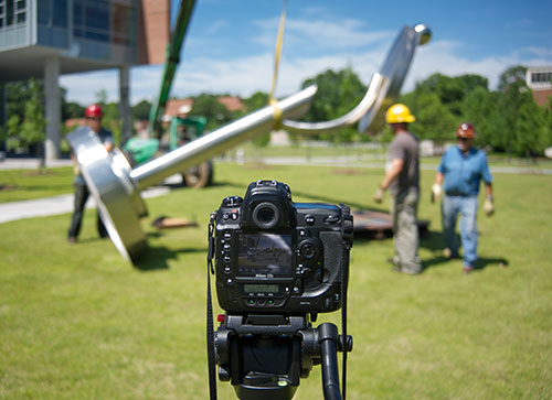 Installation of a sculpture takes place on Tech Green.