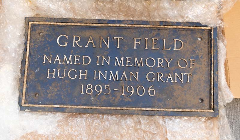 An old plaque reading 'Grant Field, named in memory of Hugh Inman Grant 1895-1906"