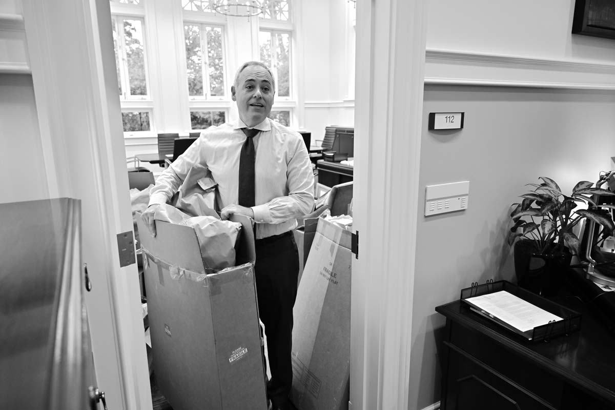 President Cabrera moving a cardboard box in his office