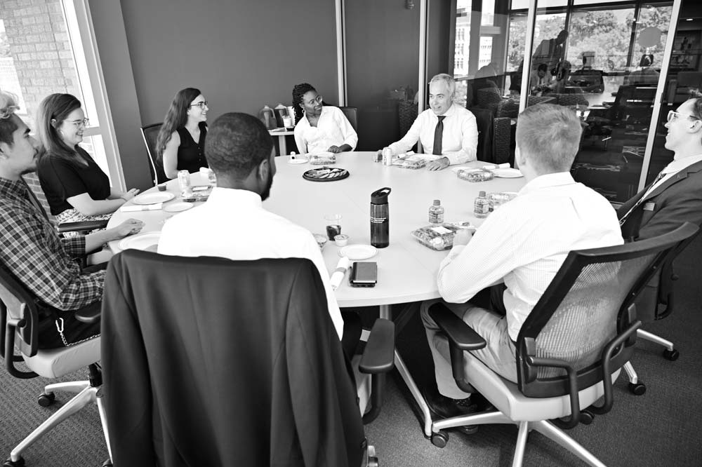 President Cabrera sitting at a large round table with students at lunch