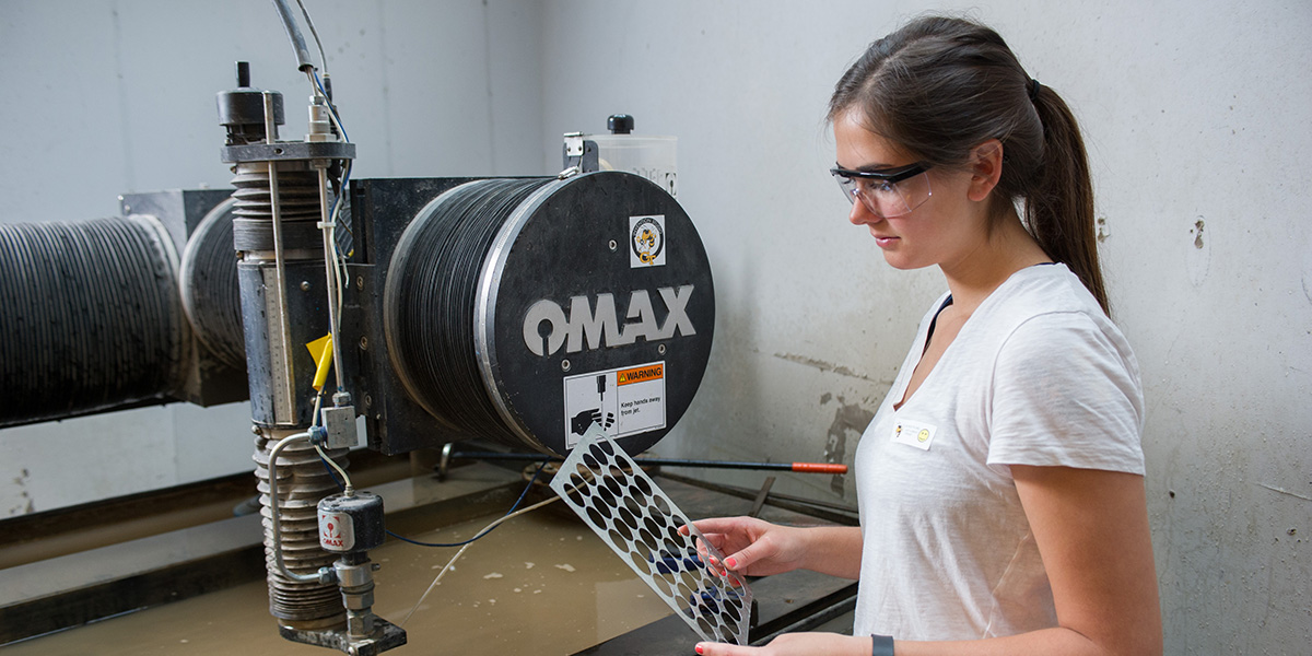 Erin Cobb, an industrial design major in the College of Architecture, is using the Invention Studio’s most expensive piece of equipment, the water jet machine. 