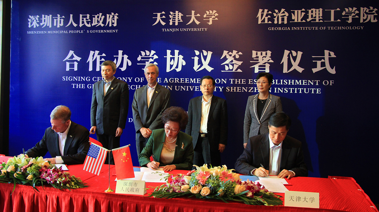 Georgia Tech’s President G. P. “Bud” Peterson, seated left, signed an agreement in a ceremony in Shenzhen, China, on Dec. 2 to create a new collaboration with the city of Shenzhen and Tianjin University. Co-signers with Peterson are Vice Mayor Yihuan Wu of Shenzhen Municipal People's Government, center, and Tianjin University President Denghua Zhong, right.