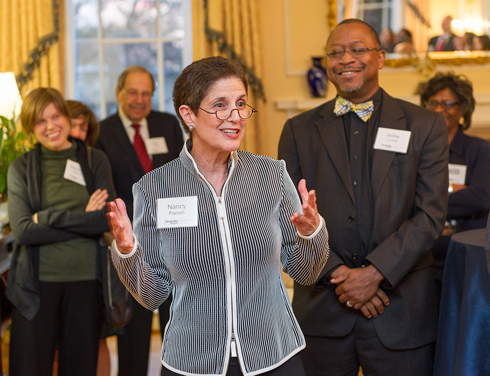 Nancy Parrish speaking to a crowd at a reception