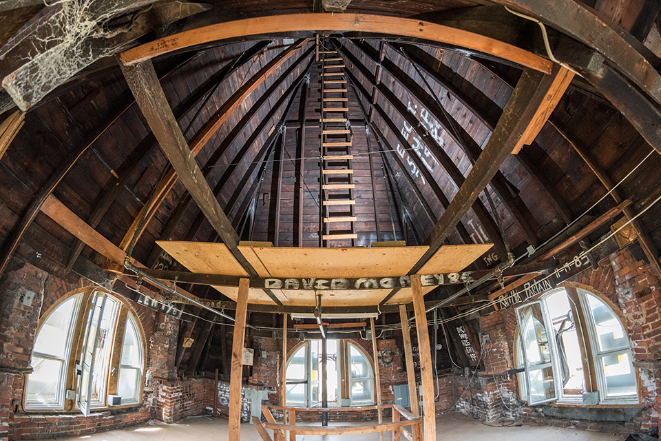 Interior of the top of Tech Tower, showing wooden beams and cobwebs