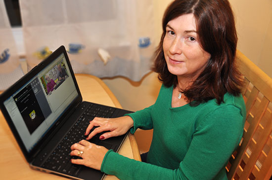 Subject sitting at her dining room table with a PC laptop and watching one of the OMSCS lectures