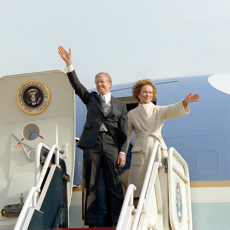 photo - Jimmy and Rosalynn Carter waving from the stairs of Air Force One