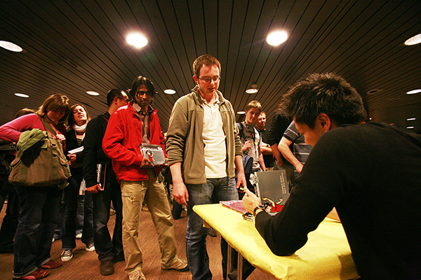 Jorge Cham signs his newest book, "We Have No Idea."