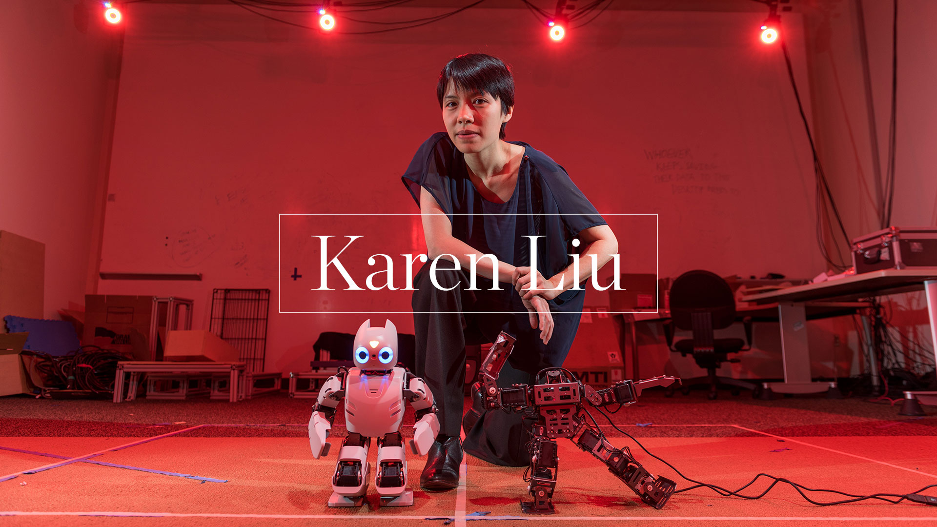 photo -  Karen Liu in lab with two small robots