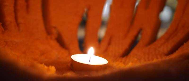Closeup of a candle inside of a jack o'lantern