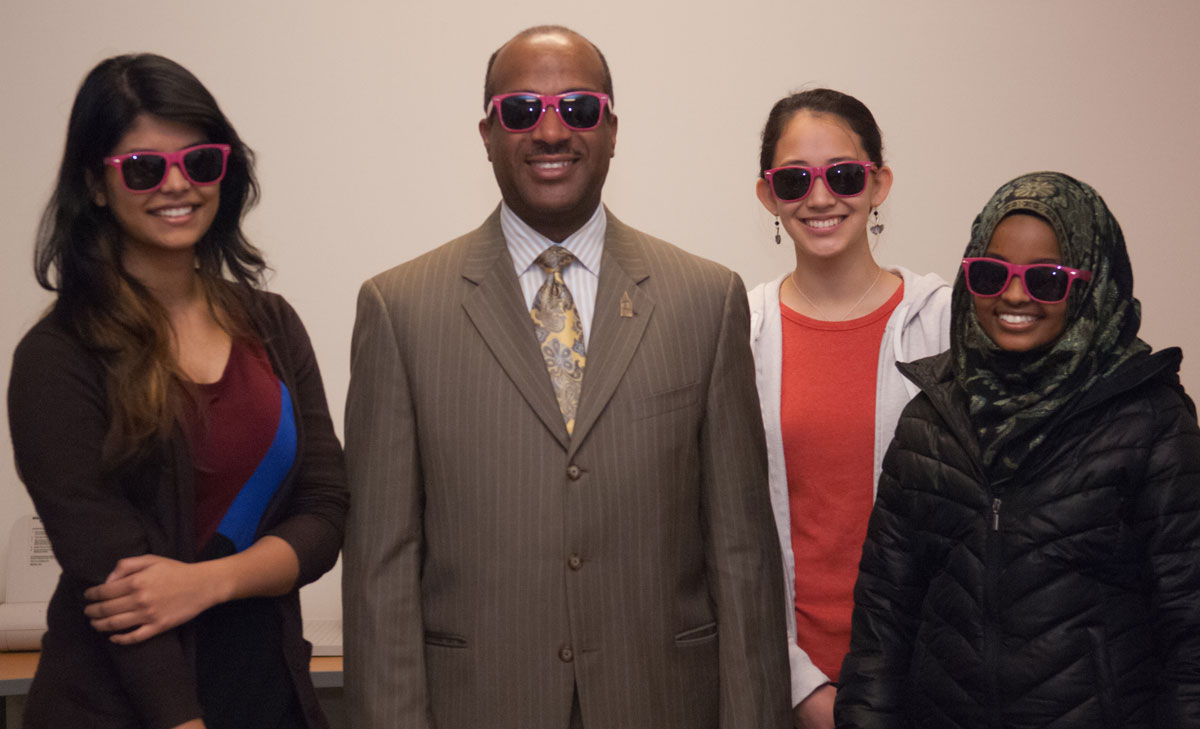 Gary May, Dean of the college of engineering poses with three female students at Chamblee High School