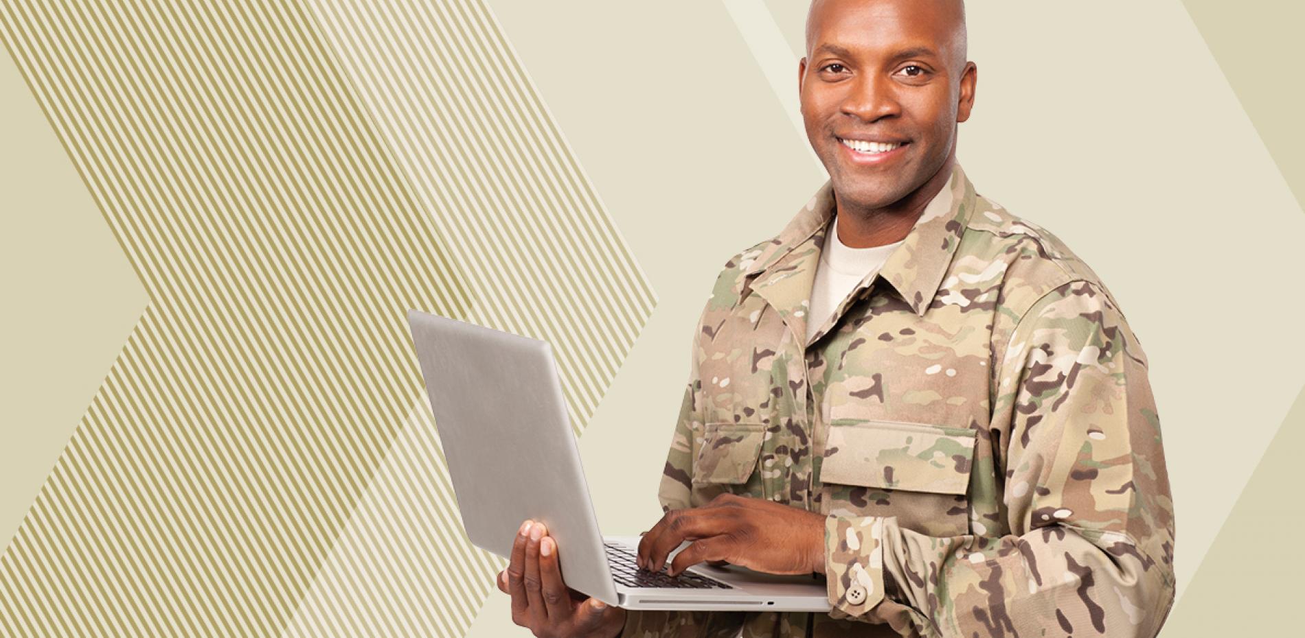 A soldier in camoflauge with a laptop