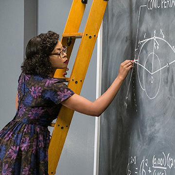 Scene from film Hidden Figures - woman writing equations on large blackboard