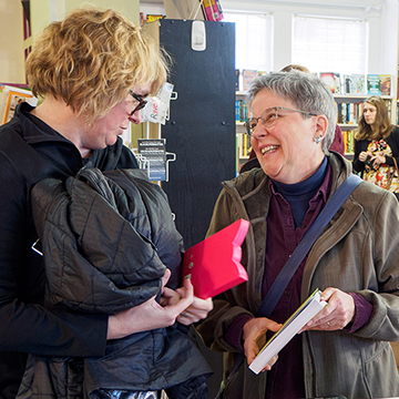 women talking at charis bookstore