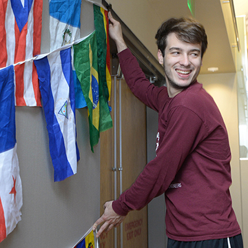 student hanging up flags