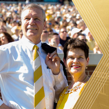 President Peterson and Val Peterson on the Georgia Tech Field in the sunshine