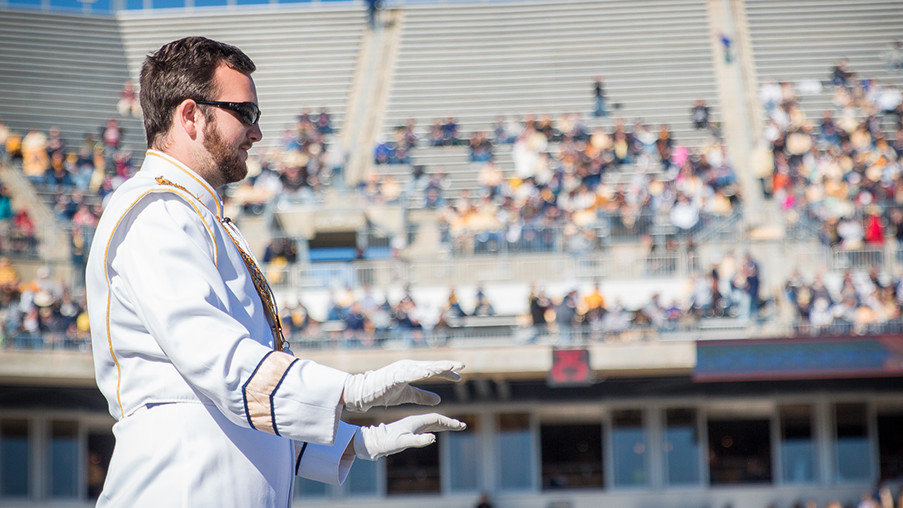 Drum major Andrew Joyce leads the Georgia Tech Marching Band from the field during a home football game. 