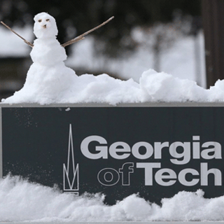 A little snow man on top of the Georgia Tech sign.