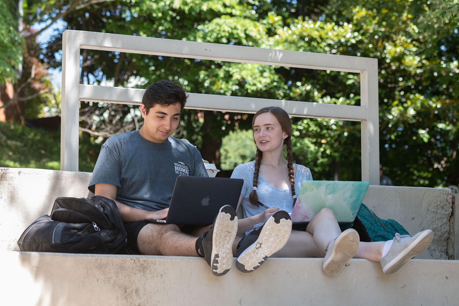 Sultan Sayedzada and Kelsey Archer study in the shade at the Kessler Campanile.