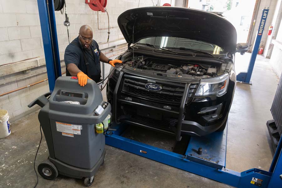 John Horne, ASE-certified mechanic, checks the air-conditioning system in a Georgia Tech police car.