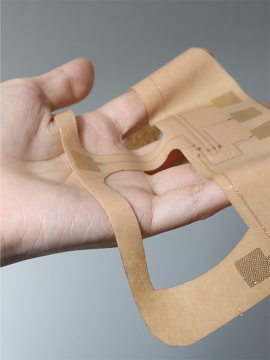The wearable sleep monitor patch, seen here, molds to the patient's face but only has the thickness and weight of an adhesive bandage.