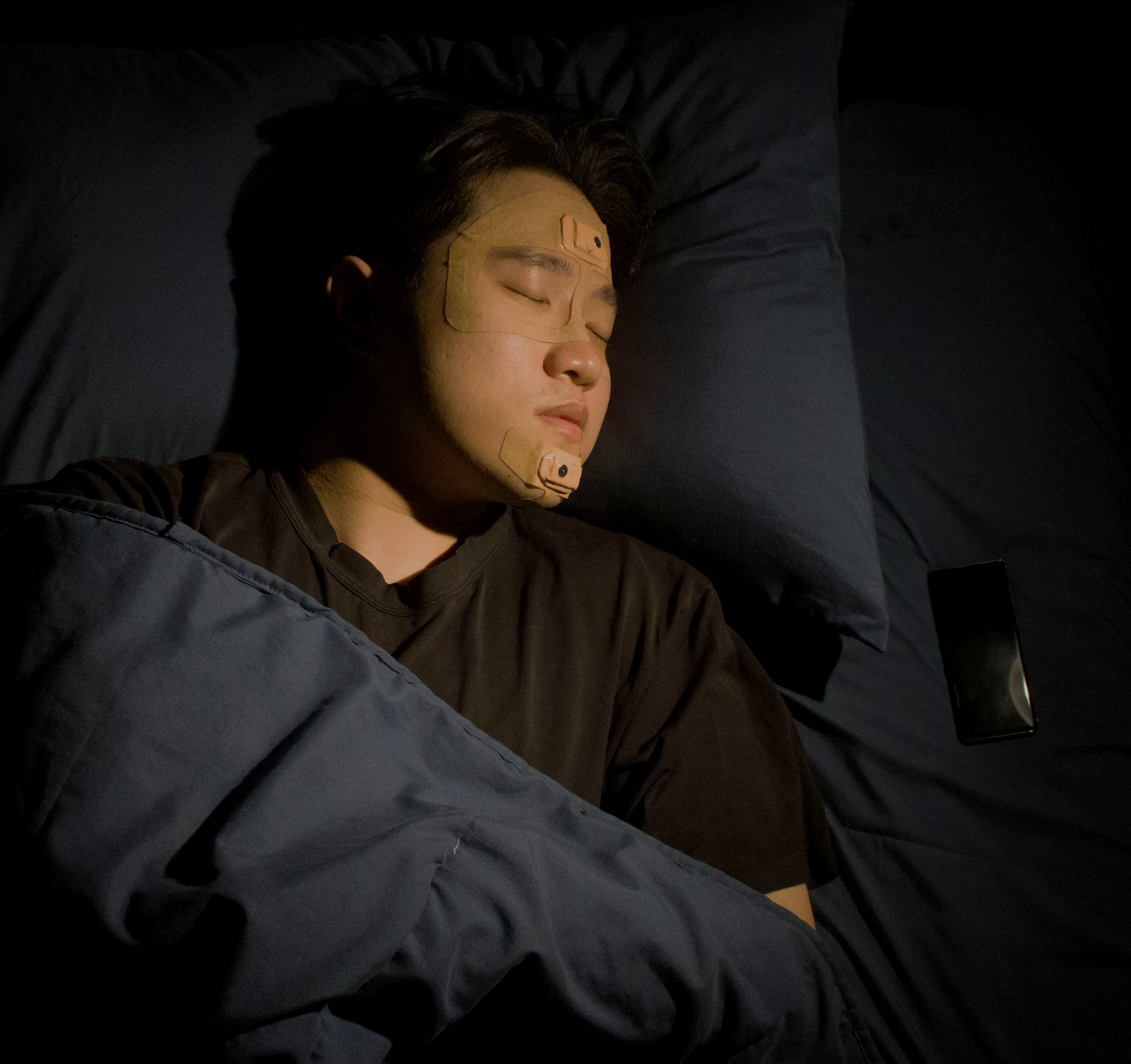  Georgia Tech Associate Professor W. Hong Yeo is shown sleeping with the wearable sleep apnea detection and sleep quality monitoring device he and a team of researchers and clinicians created.  Georgia Tech Associate Professor W. Hong Yeo is shown sleeping with the wearable sleep apnea detection and sleep quality monitoring device he and a team of researchers and clinicians created.