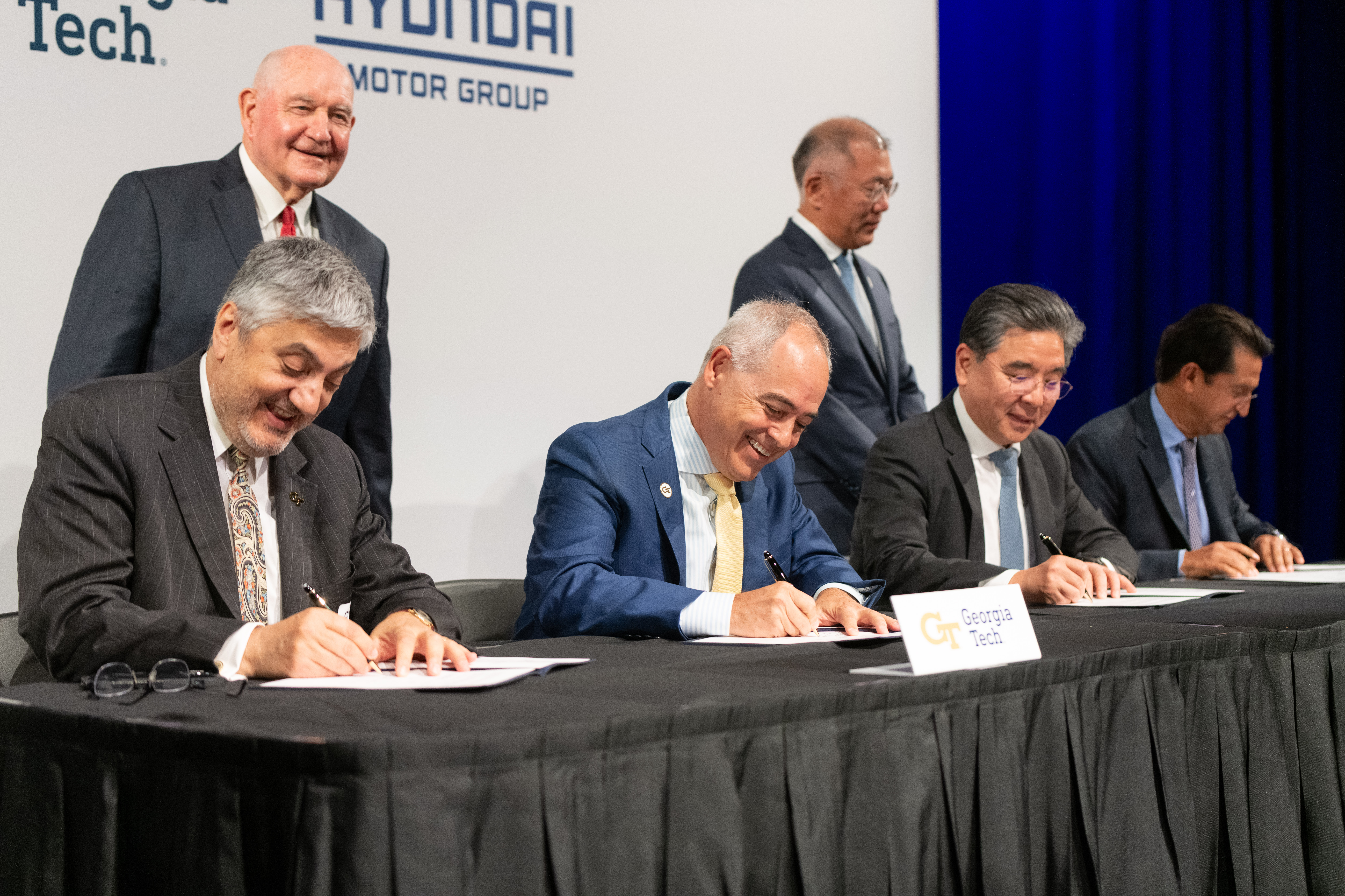 USG Chancellor Sonny Perdue looks on as Georgia Tech President Ángel Cabrera and Executive Vice President for Research Chaouki Abdallah sign the memorandum of understanding with Hyundai officials, signifying the beginning of a transformative partnership. 