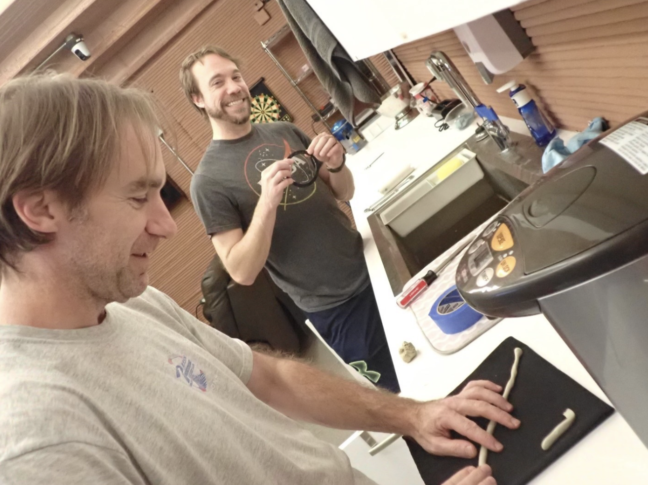 Brockwell (left) works at a station inside the habitat. Photo credit: NASA/CHAPEA