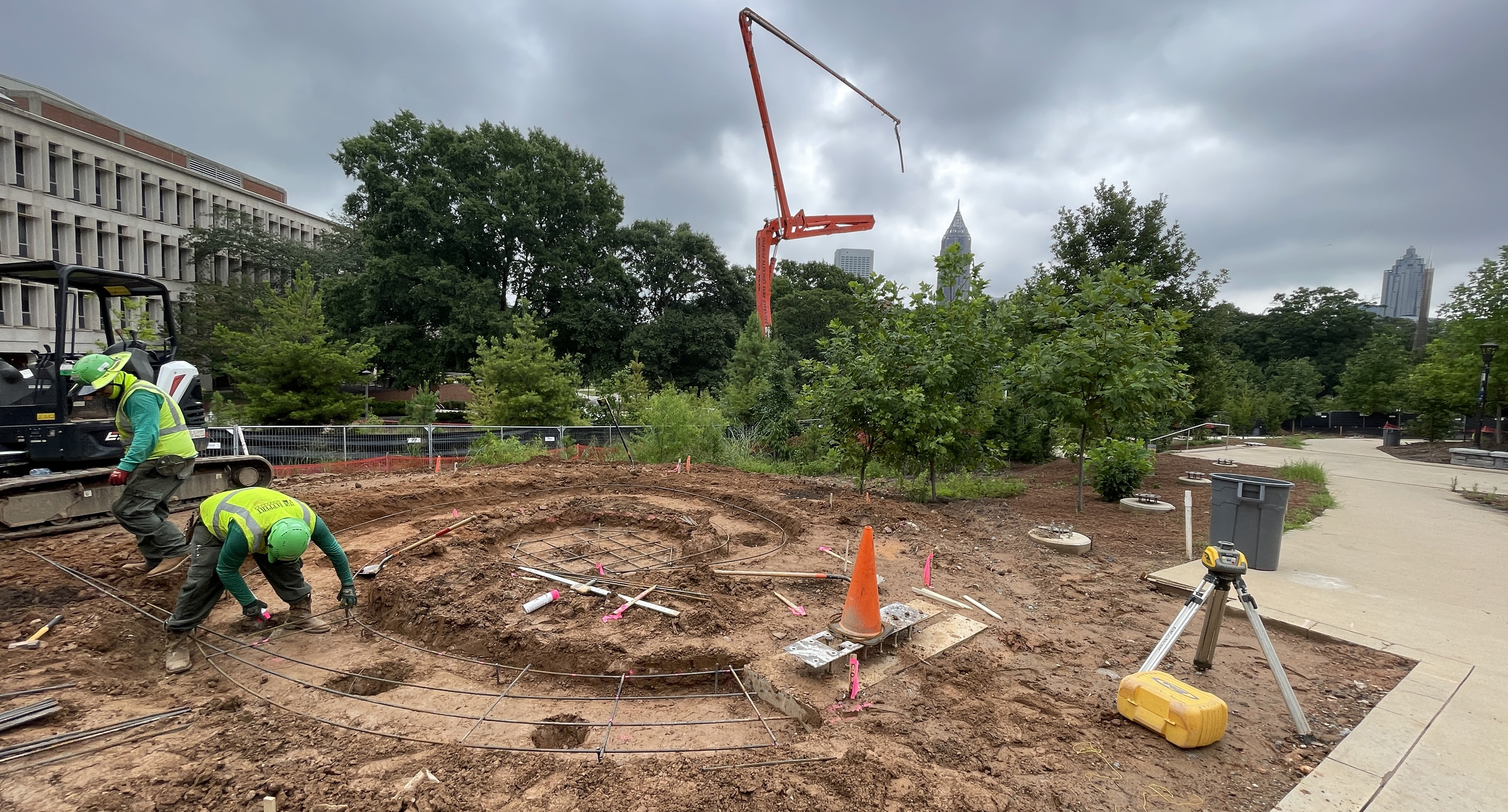 Construction workers laying rebar for outdoor installation.