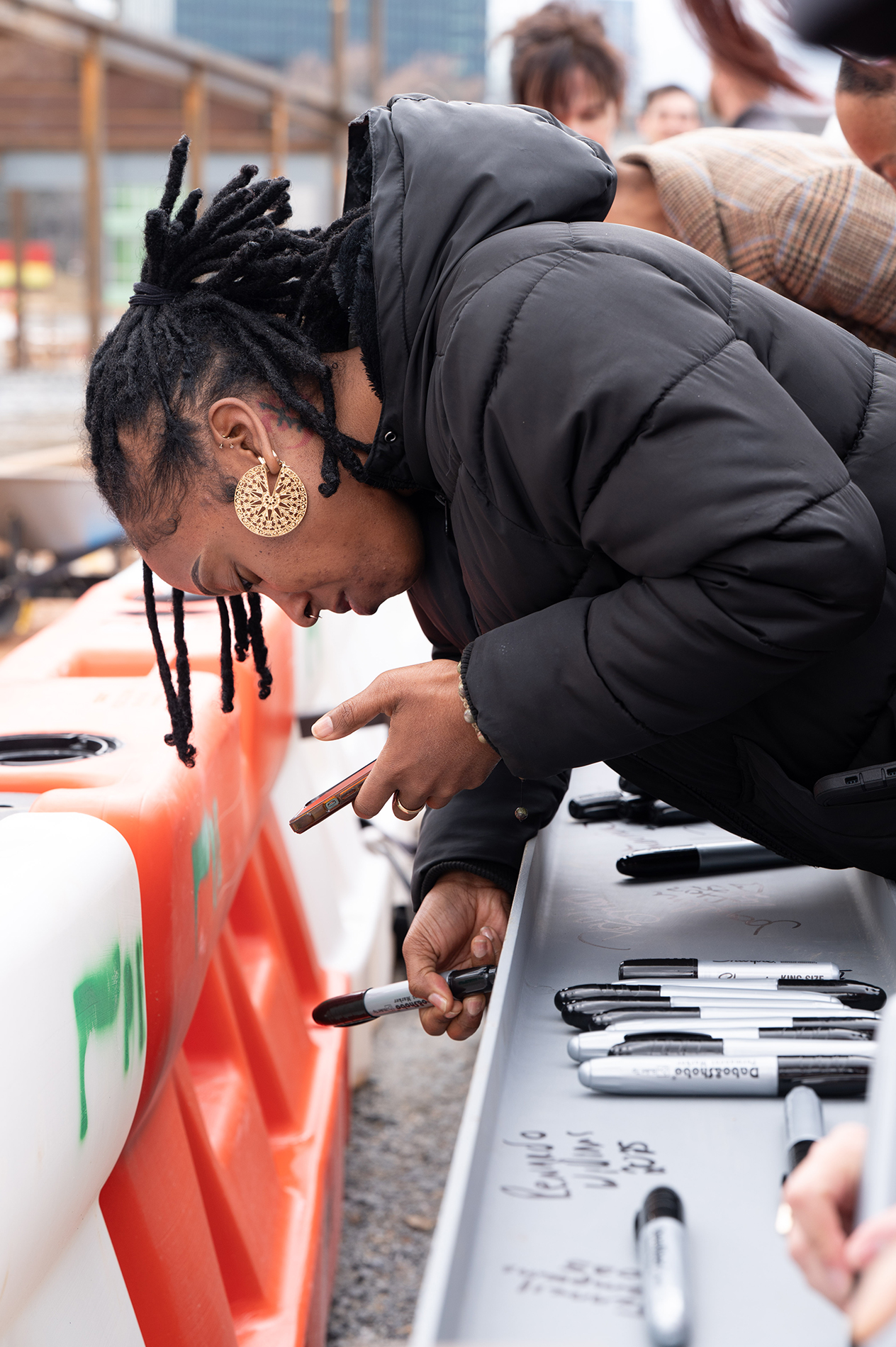 signing a beam at the groundbreaking