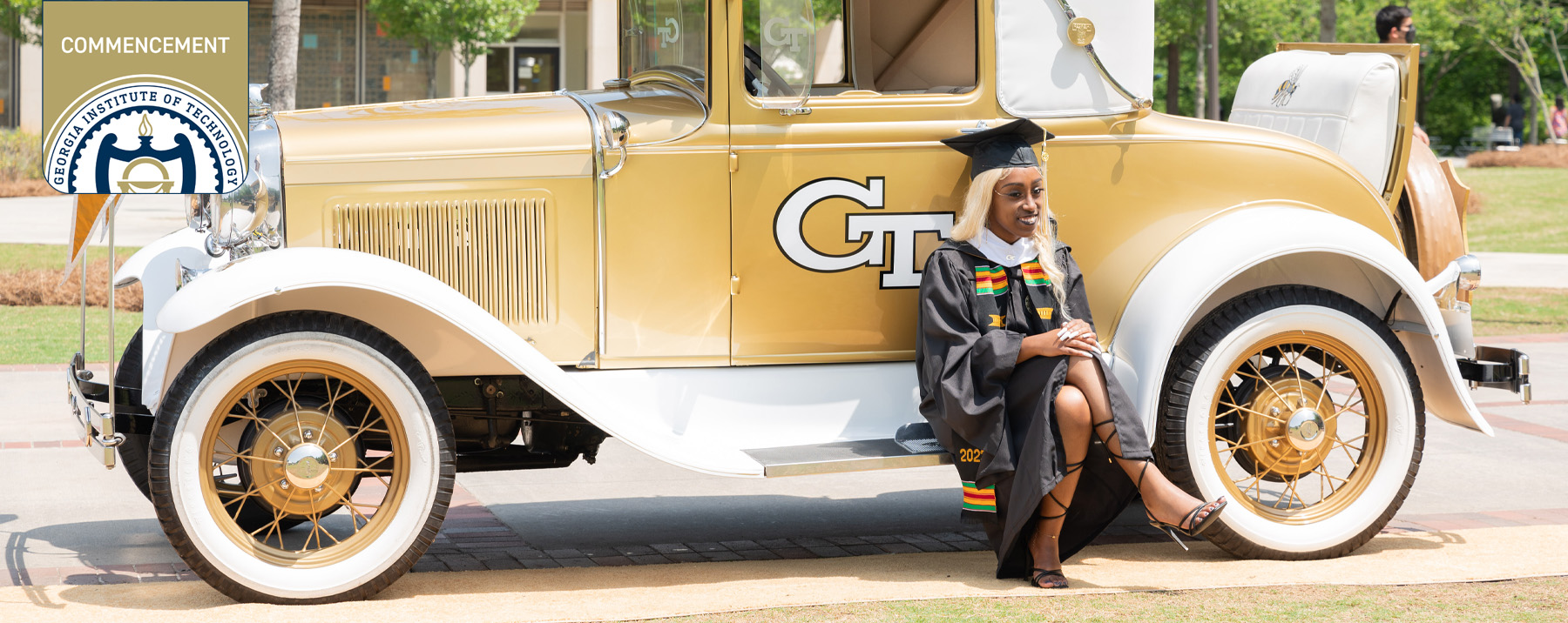 student posing in regalia