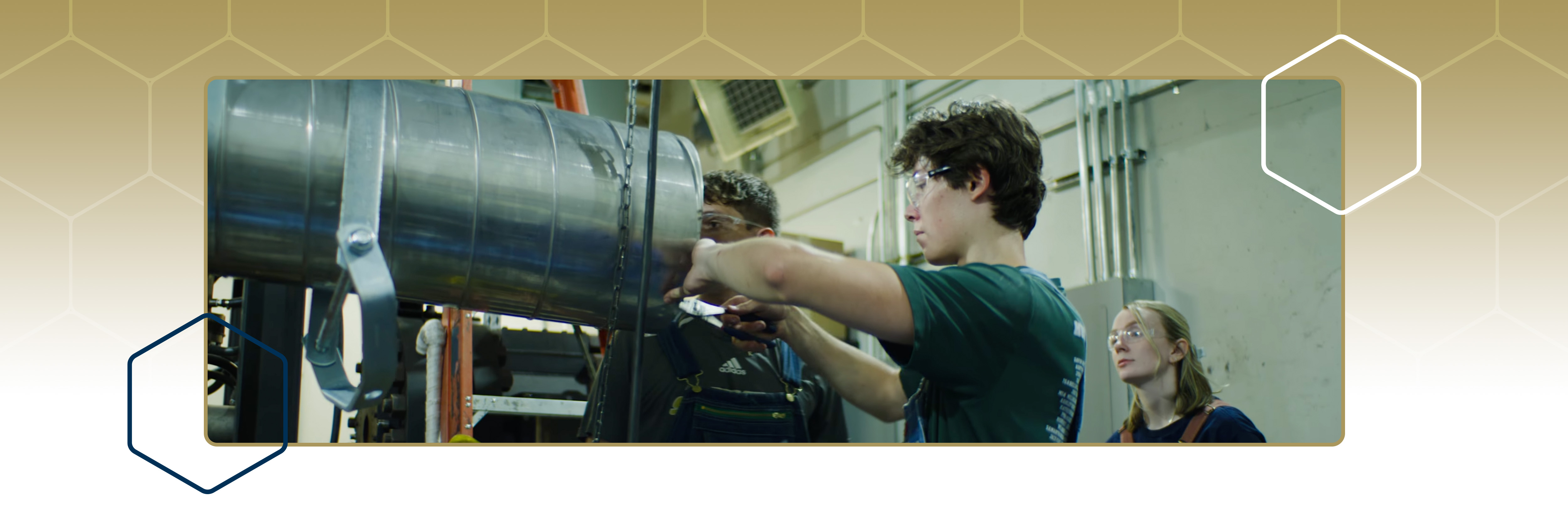 Students working in a lab on top of a gold pattern
