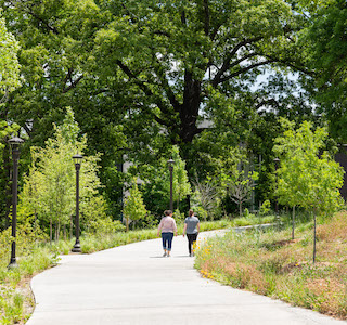 Two people on EcoCommons trail. 