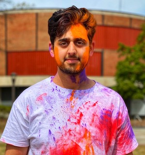 Student covered in paint from Holi event sponsored by the India Club. 
