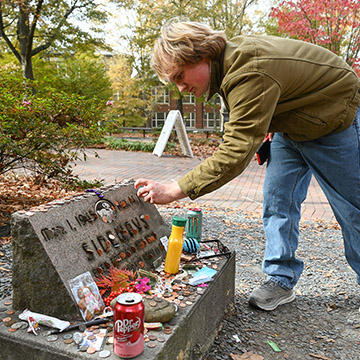 student at sideways' grave